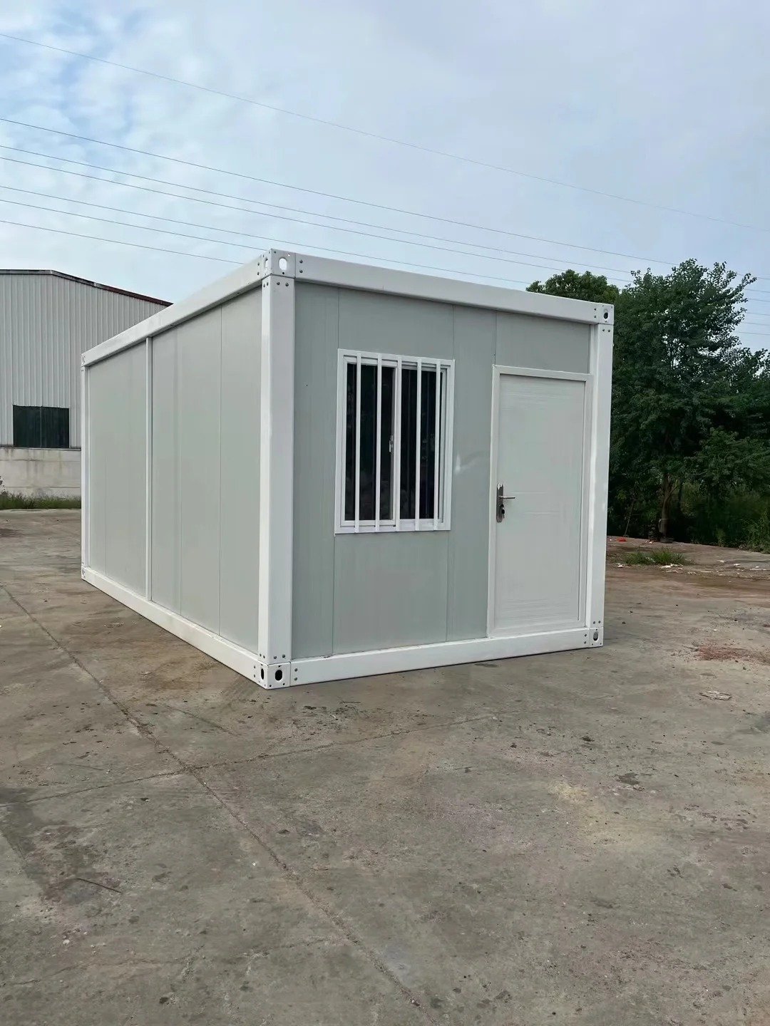 White detachable container house module inside a factory building